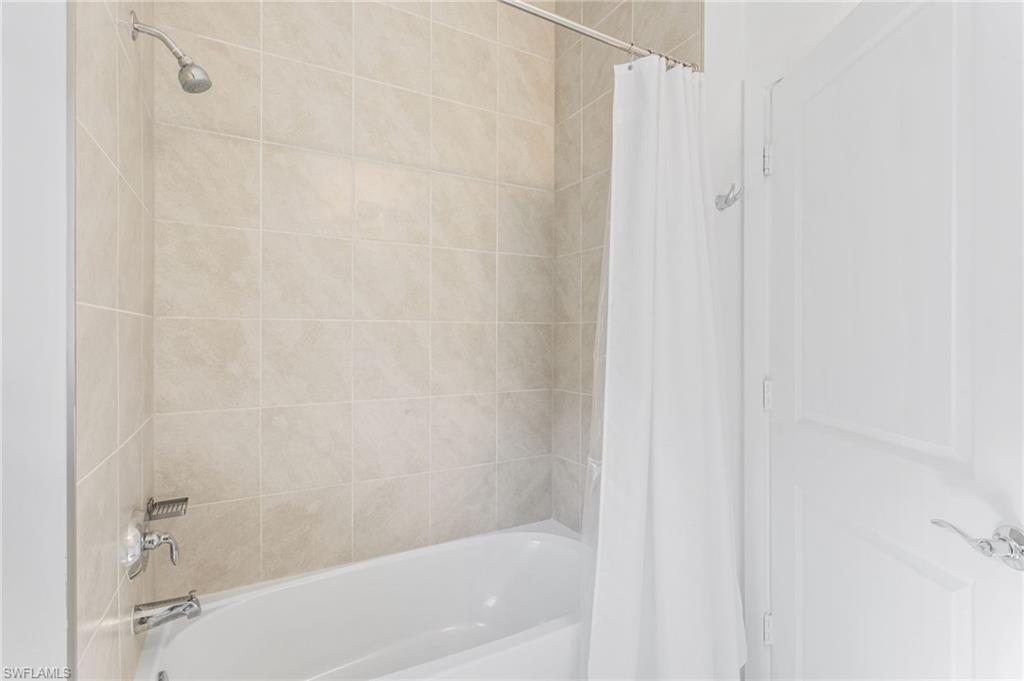 Bathroom featuring shower / bath combination with curtain