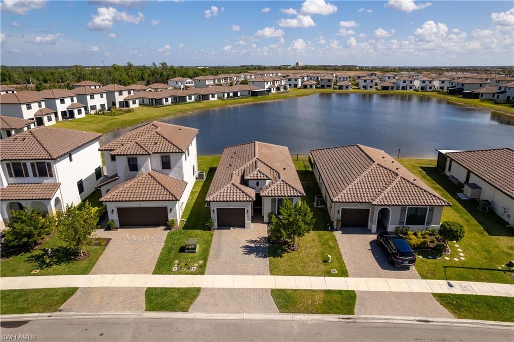 Aerial perspective of suburban area featuring a large body of water
