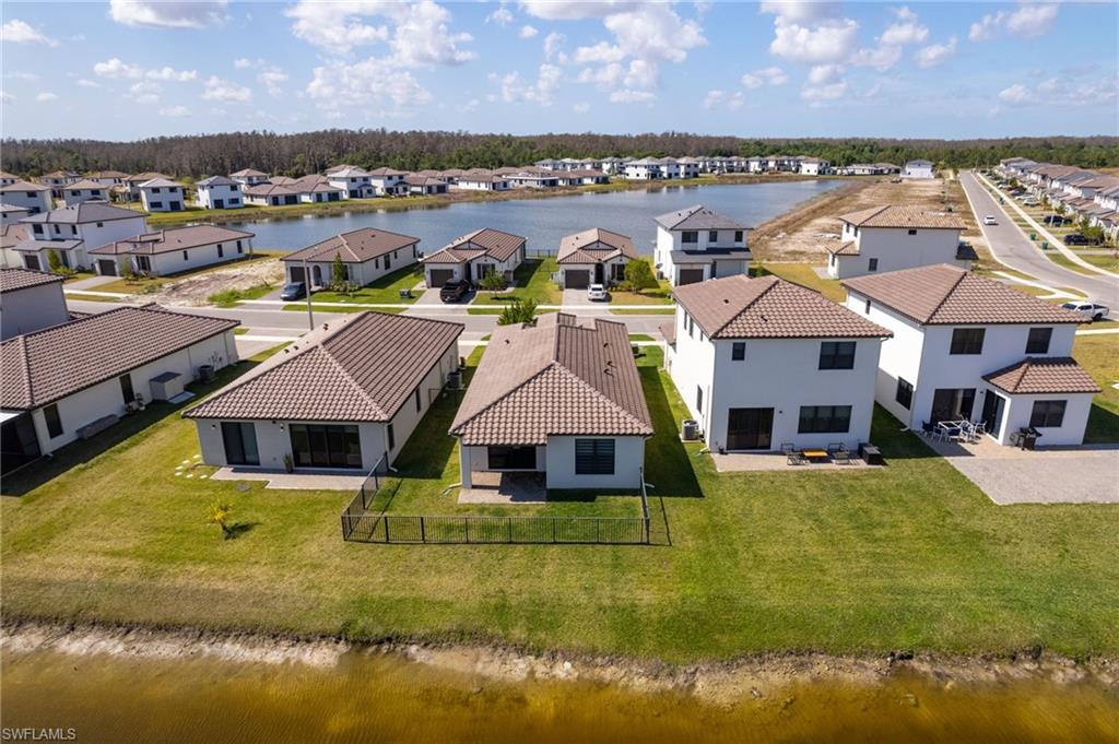Aerial perspective of suburban area featuring a nearby body of water
