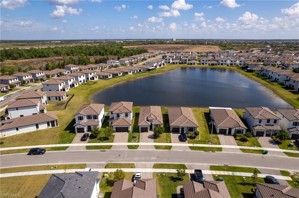 Aerial view of residential area featuring a nearby body of water