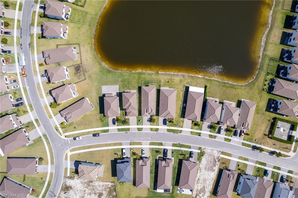 Aerial view of property's location featuring nearby suburban area and a nearby body of water