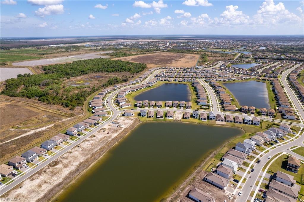 Aerial view of residential area featuring a large body of water