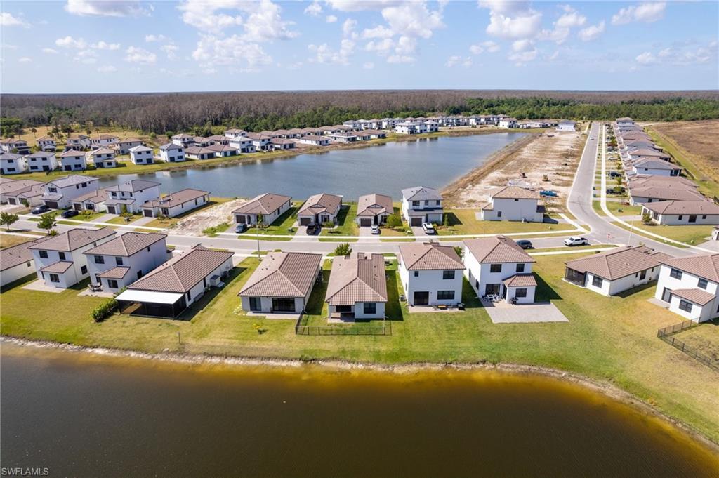 Aerial view of residential area featuring a nearby body of water