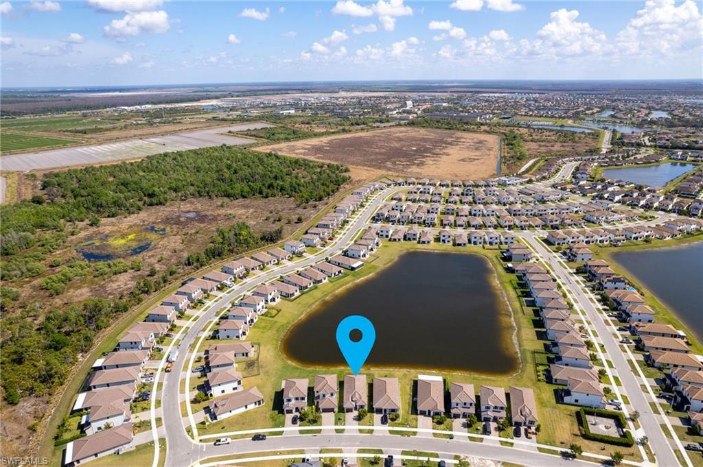 Aerial overview of property's location featuring nearby suburban area and a nearby body of water