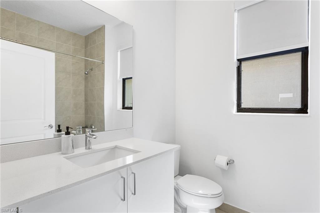 Bathroom featuring vanity and a shower