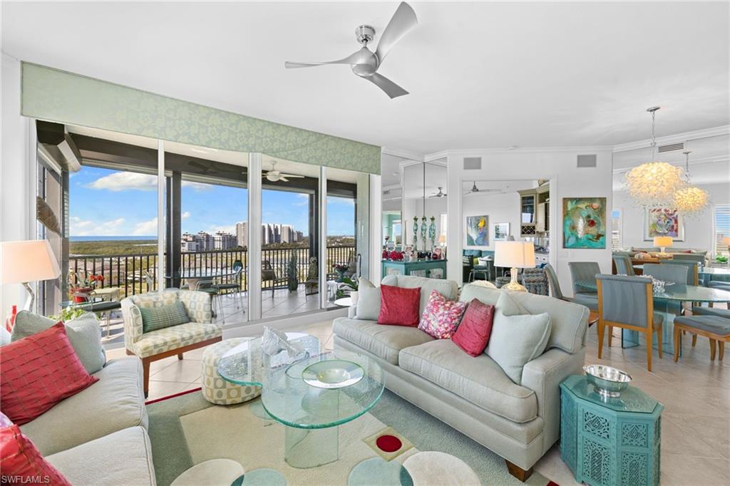 Living room featuring light tile patterned floors and a ceiling fan