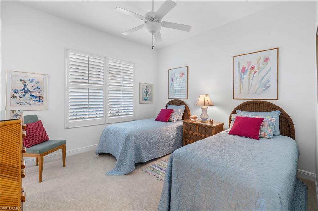 Carpeted bedroom with baseboards and ceiling fan