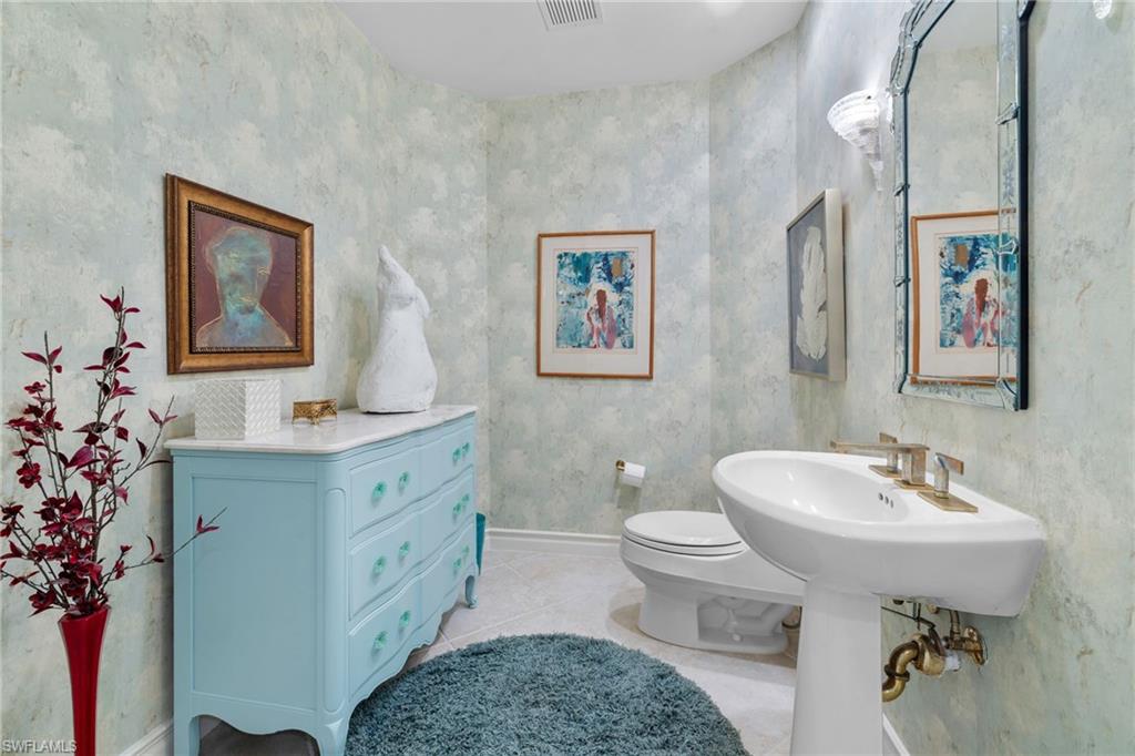 Half bathroom featuring baseboards and light tile patterned flooring