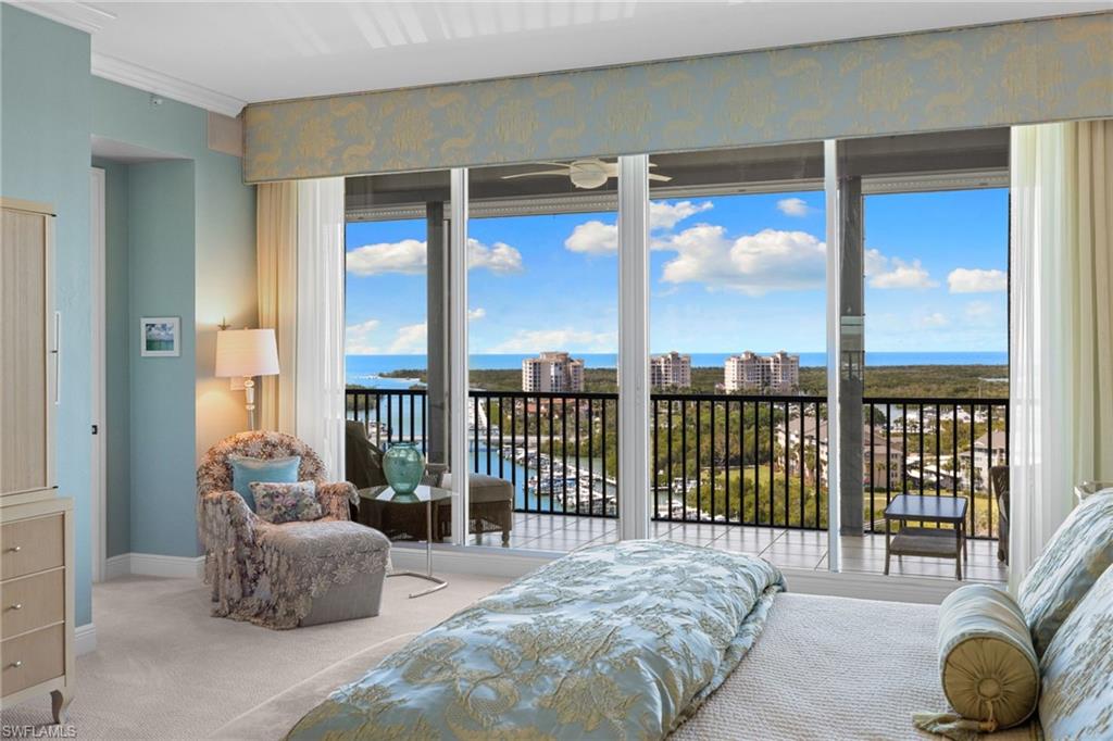 Carpeted bedroom with a water view, access to outside, and ornamental molding