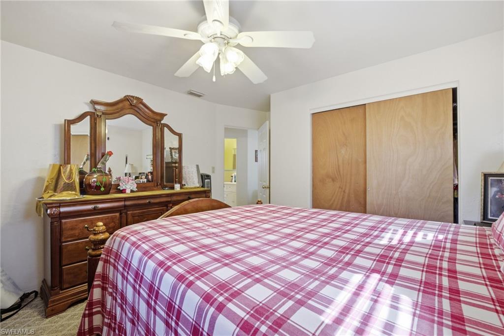 Bedroom with ceiling fan and a closet