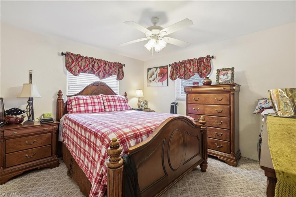 Bedroom featuring a ceiling fan and light carpet