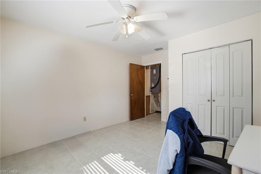 Office area with ceiling fan and light tile patterned floors