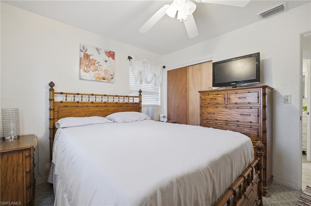 Bedroom featuring ceiling fan and a closet
