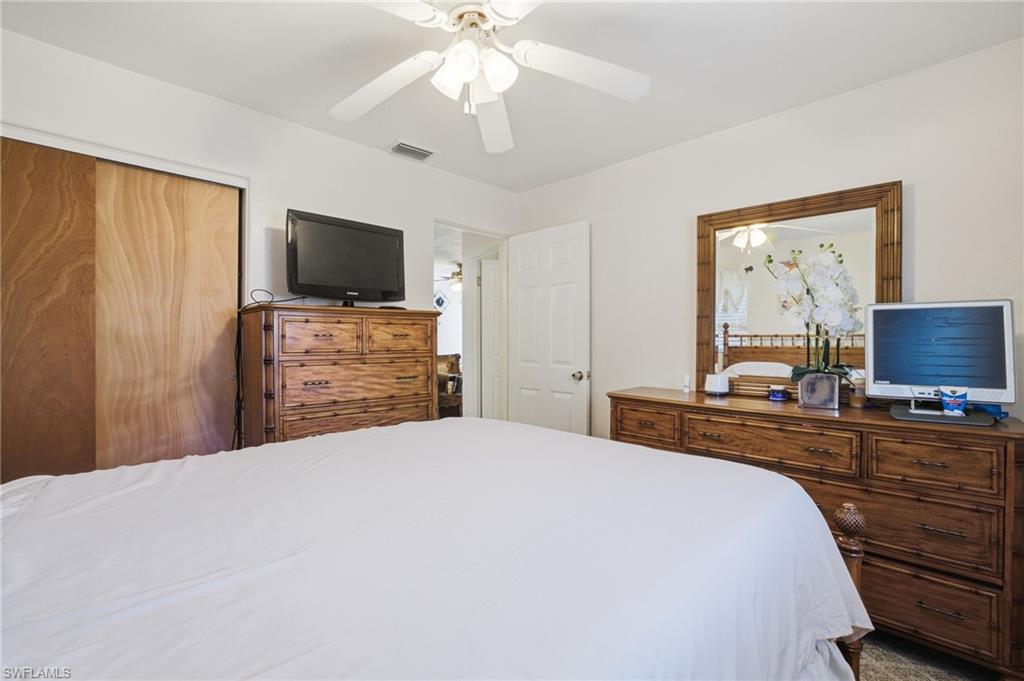 Bedroom featuring a ceiling fan and a closet