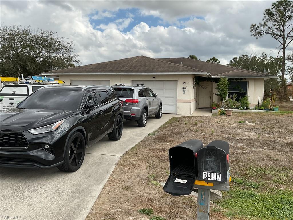 Ranch-style duplex with a garage, concrete driveway, and a shingled roof