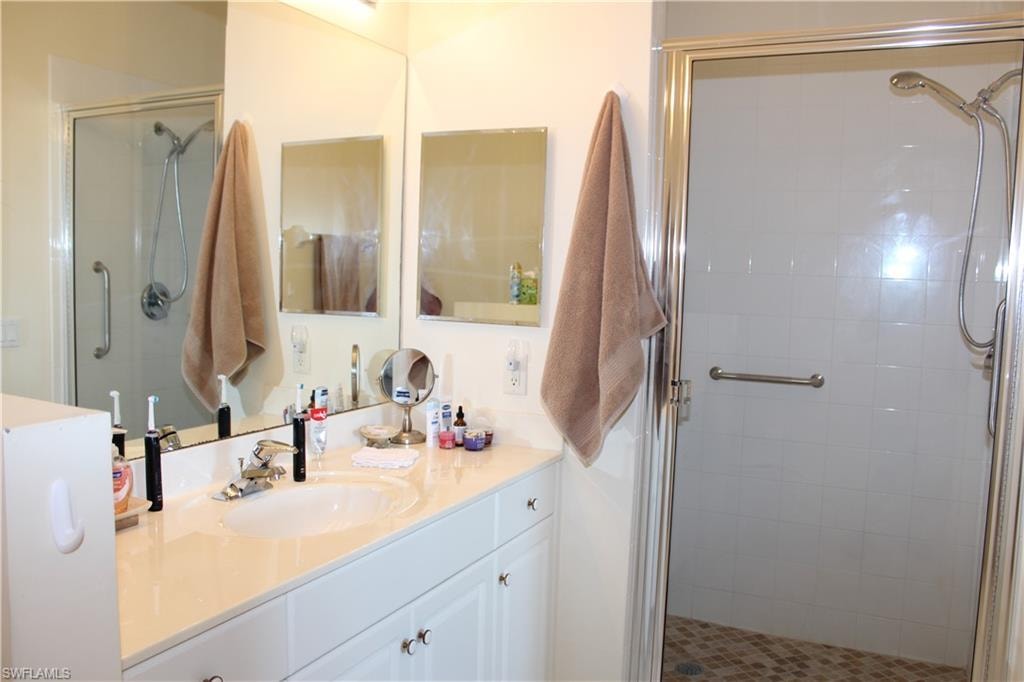 Bathroom featuring vanity and a stall shower