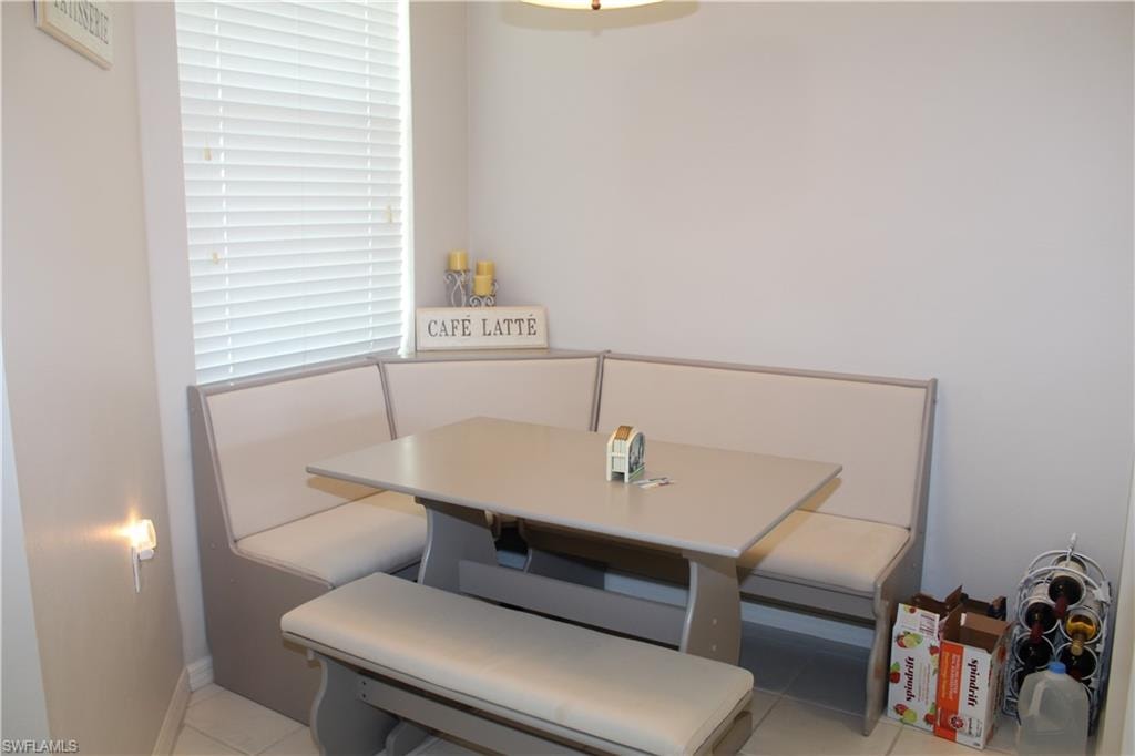 Dining area featuring light tile patterned flooring