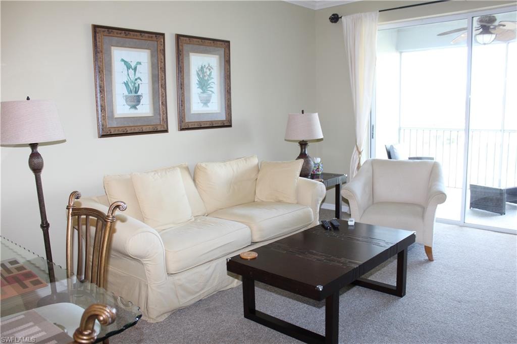Living area with carpet flooring and a ceiling fan