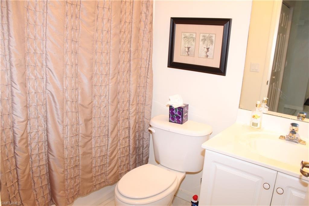 Full bath with a shower with shower curtain and vanity