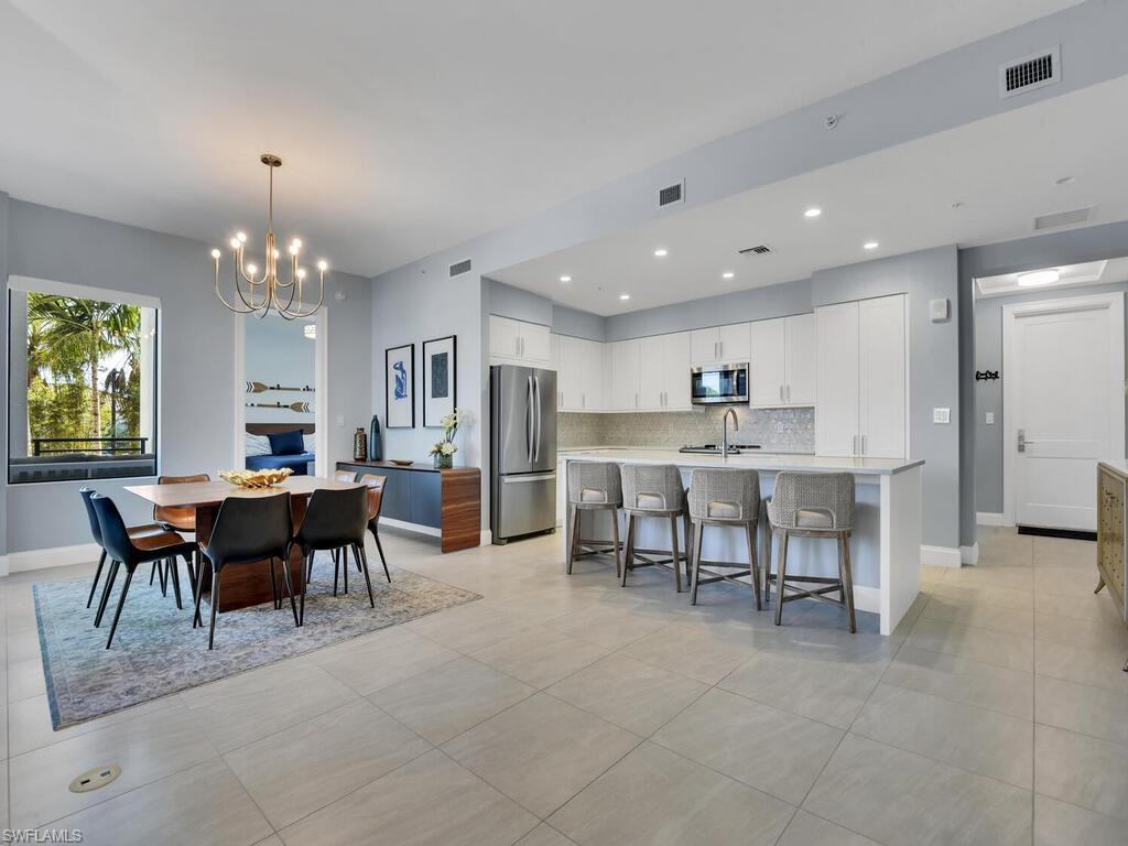 Dining space featuring a chandelier and light tile patterned floors