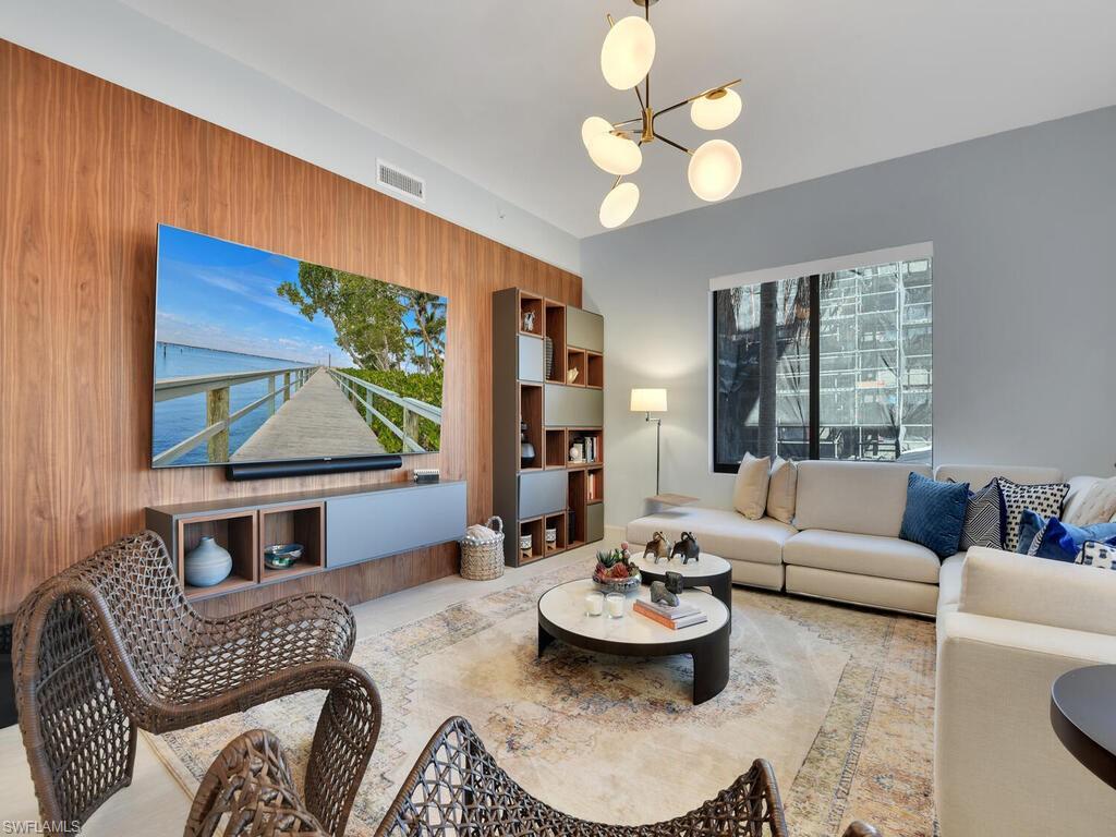 Living area featuring a chandelier and wood walls