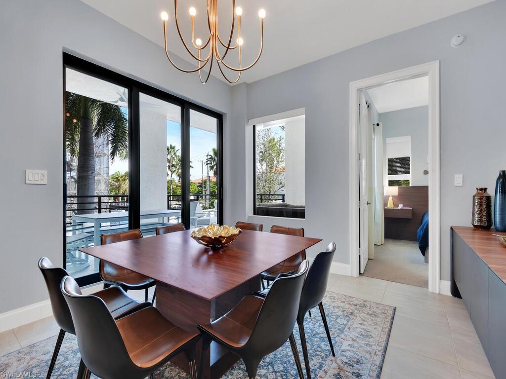 Dining room featuring hanging lights and light tile patterned flooring