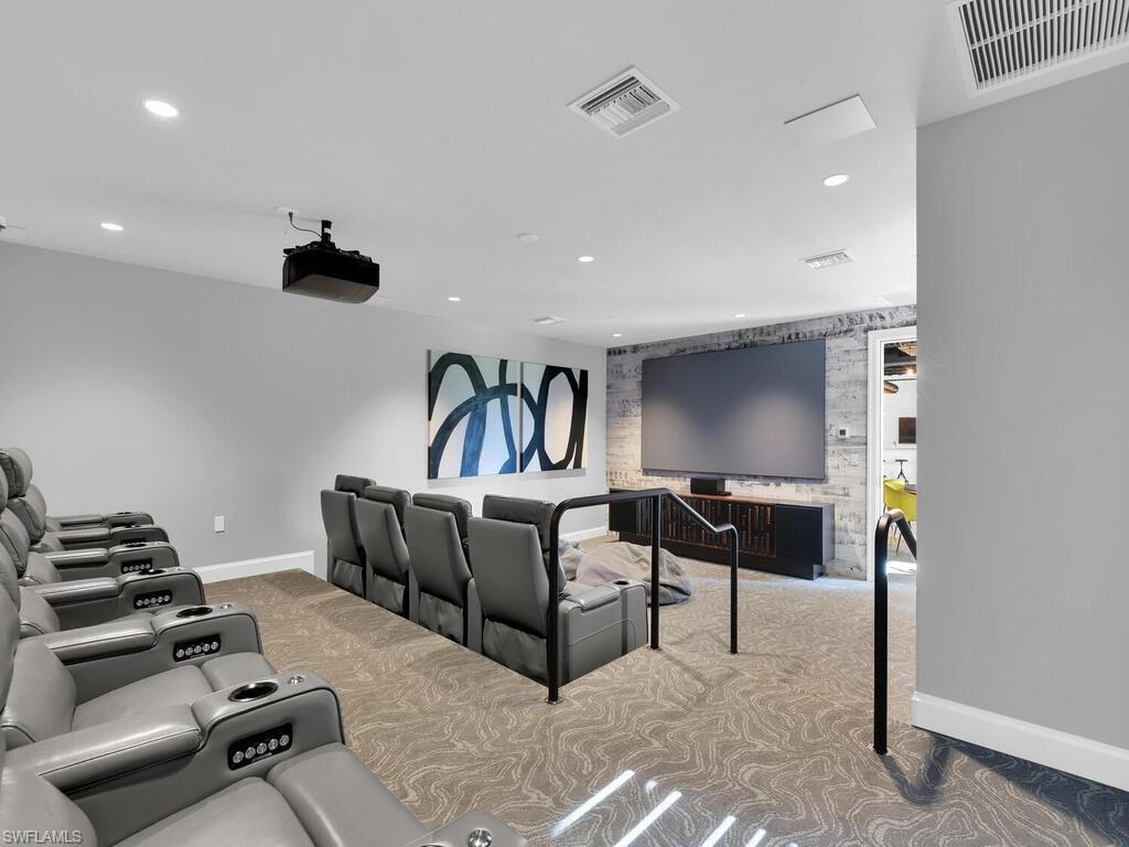 Cinema room with light carpet and recessed lighting