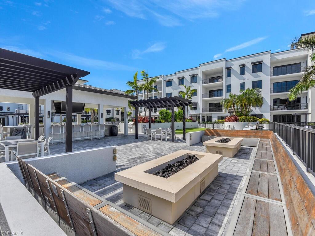 View of patio / terrace with a pergola, a fire pit, and outdoor dining area