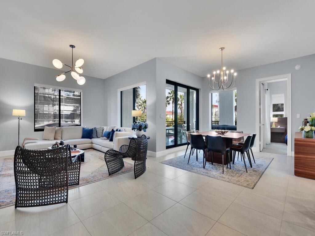 Living area with suspended lighting and light tile patterned floors