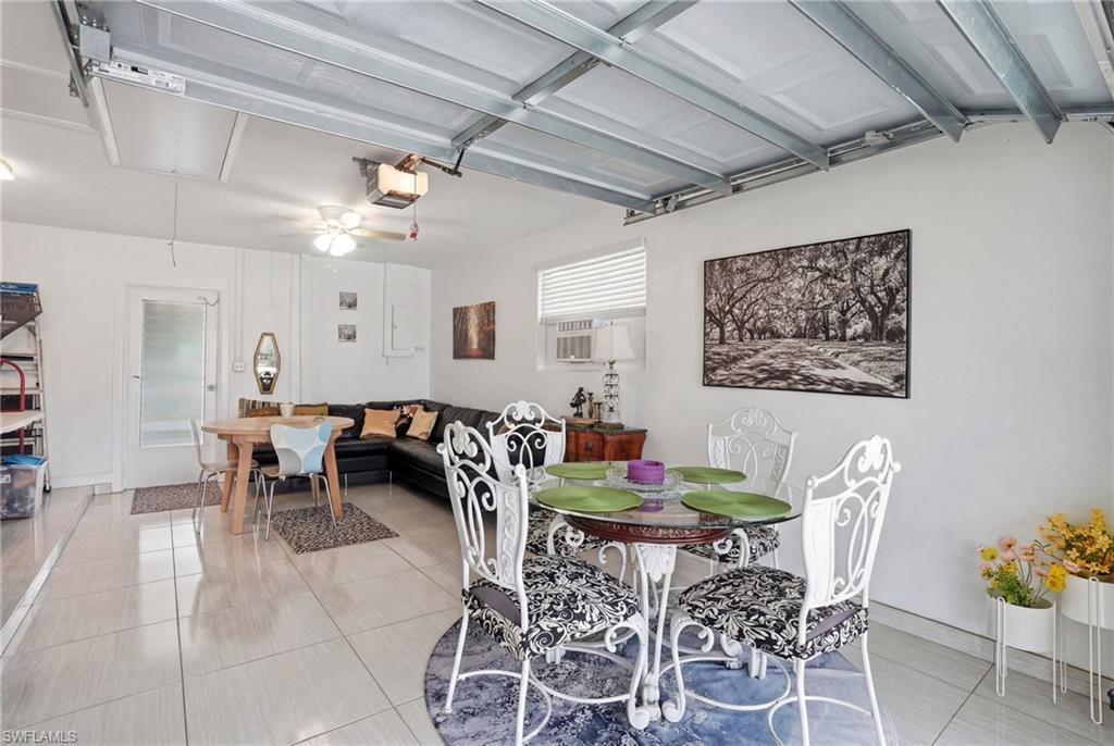 Dining area featuring light tile patterned floors and cooling unit