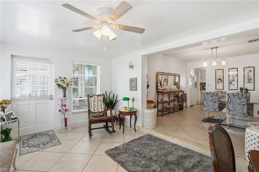 Foyer featuring light tile patterned floors and ceiling fan