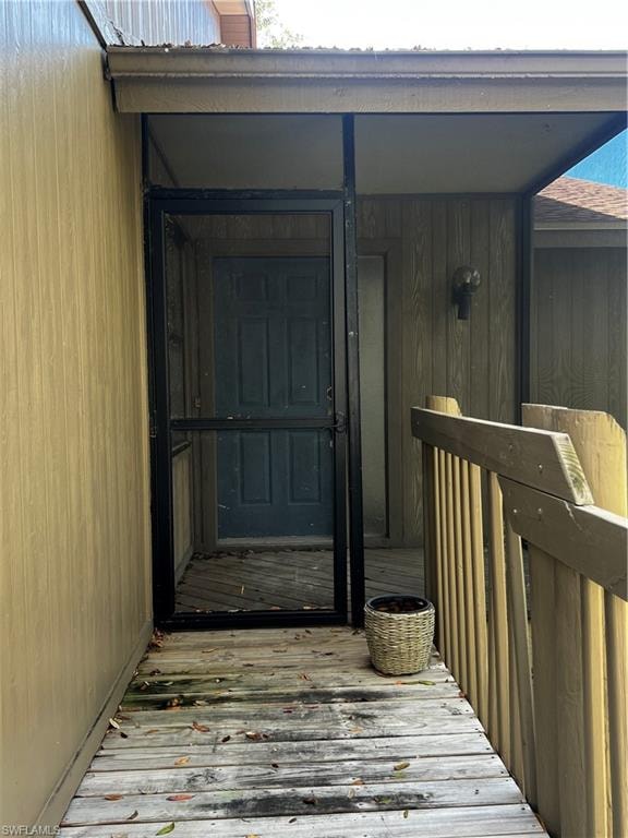 View of exterior entry with a deck and a chimney