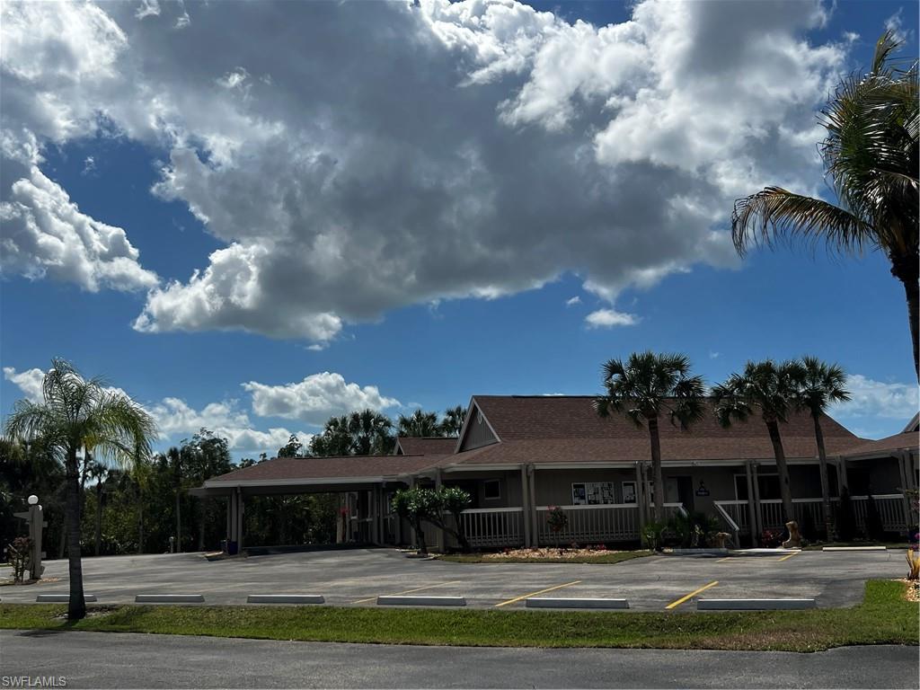 View of property featuring uncovered parking