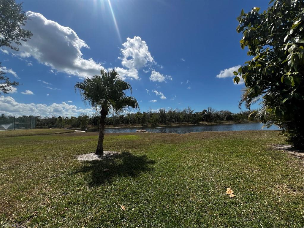 View of green lawn with a water view