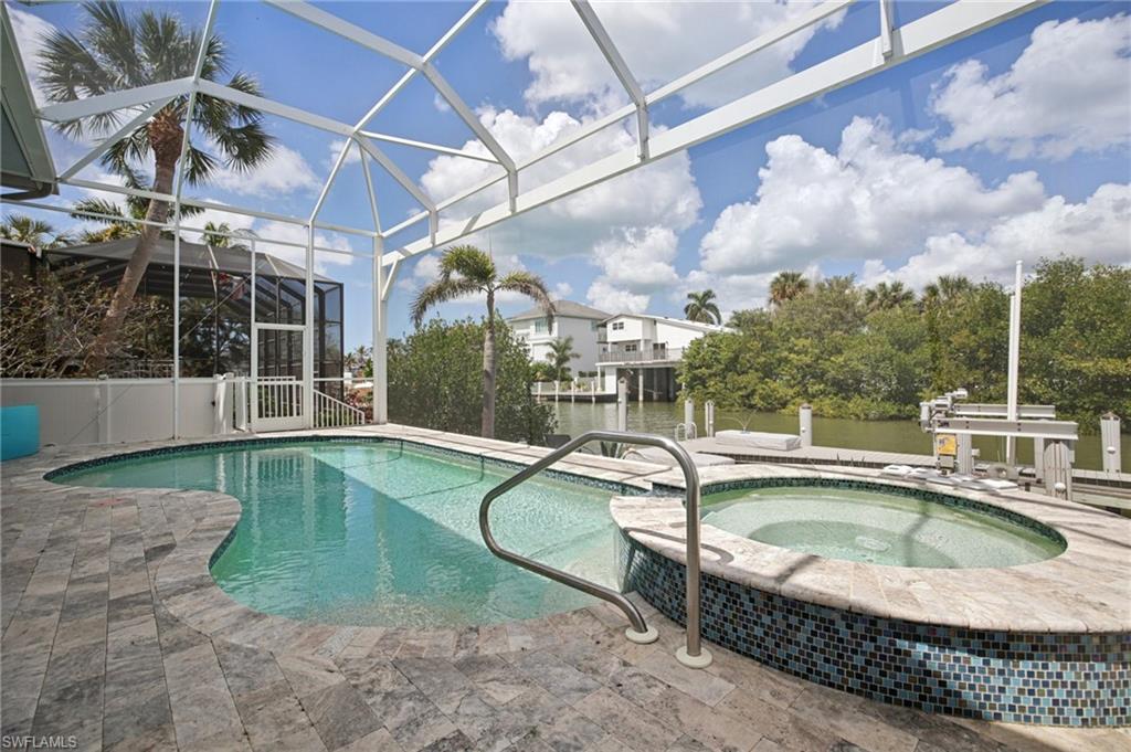 Pool with spa, and spacious seating is completely screen enclosed