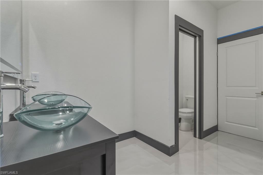 Bathroom featuring toilet and double vanity