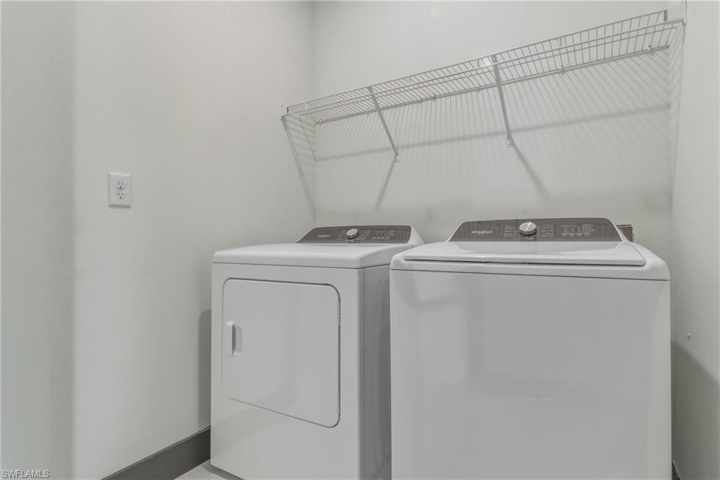 Laundry room featuring independent washer and dryer and baseboards