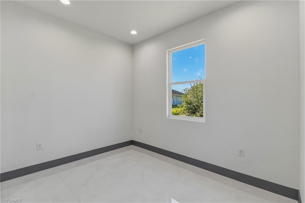 Spare room featuring recessed lighting and baseboards