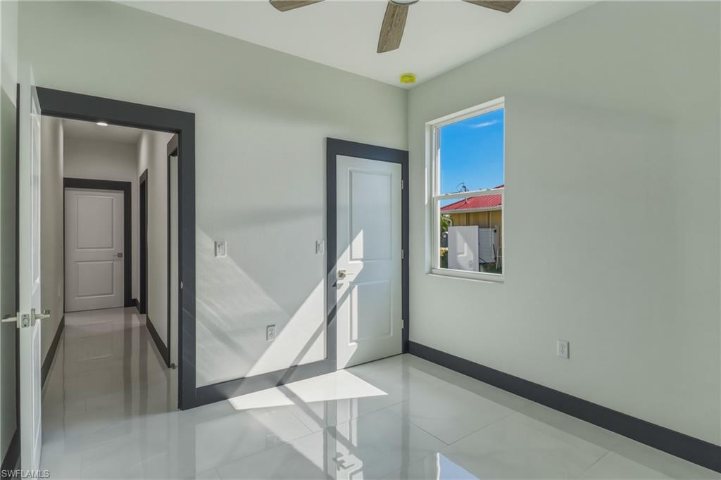 Spare room with baseboards and ceiling fan