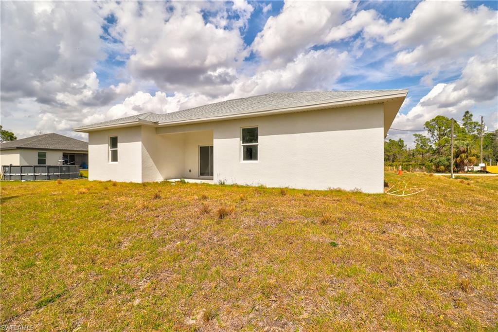 Rear view of property with stucco siding and a patio area