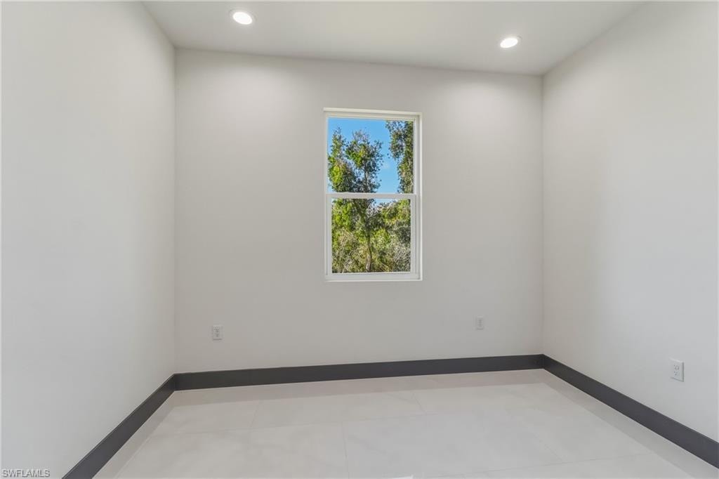 Spare room with recessed lighting and baseboards