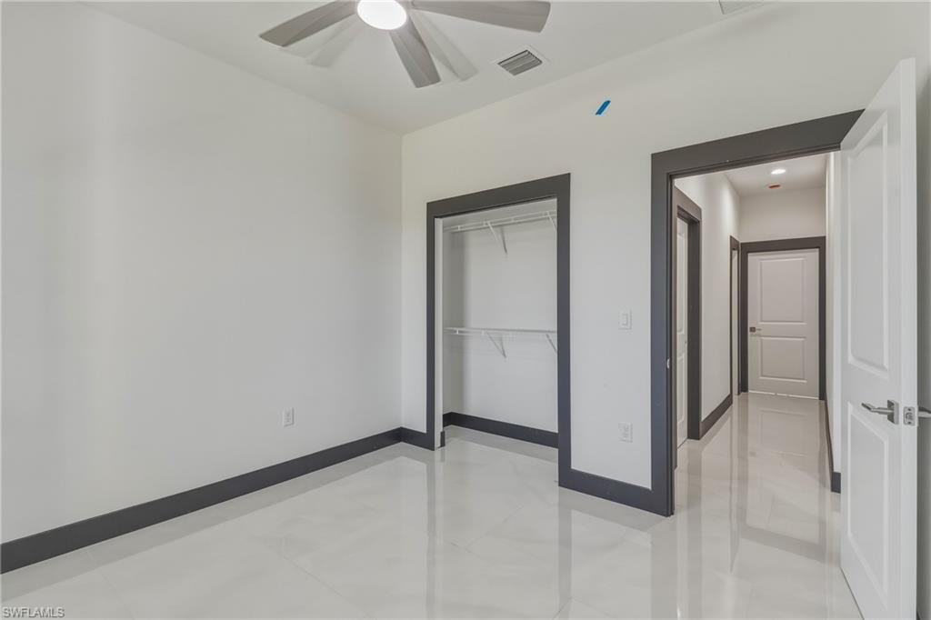 Unfurnished bedroom featuring a closet and ceiling fan