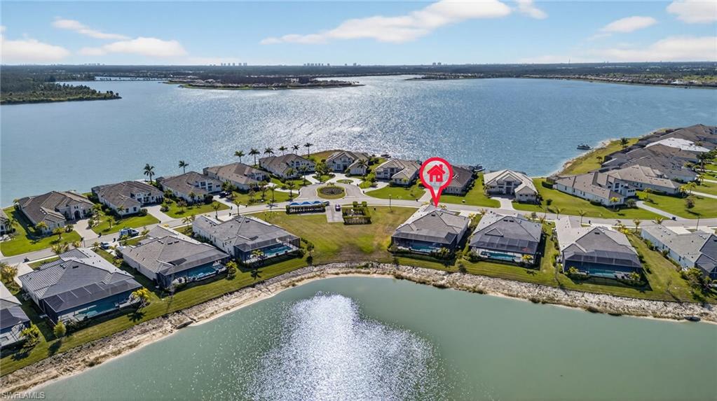 Aerial perspective of suburban area featuring a nearby body of water