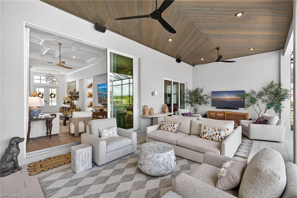 Living area with ceiling fan, wood ceiling, high coffered ceiling, and recessed lighting