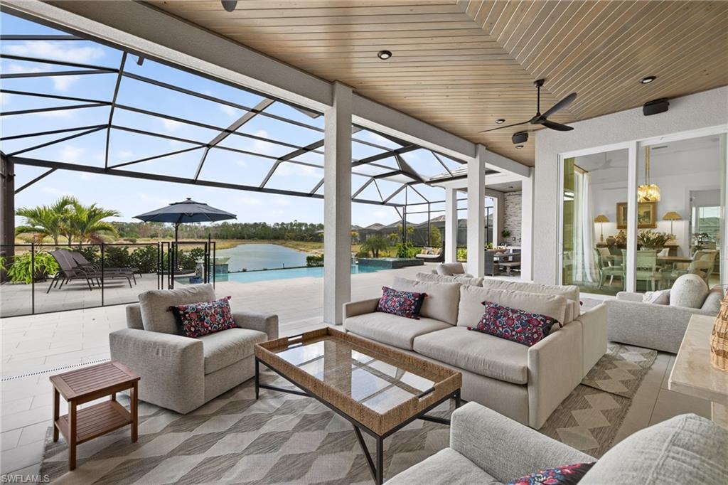 View of patio / terrace with a sunroom, a lanai, and outdoor furniture