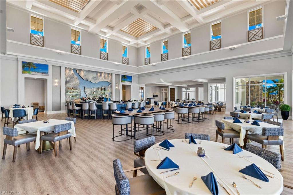 Dining area with light wood finished floors and coffered ceiling