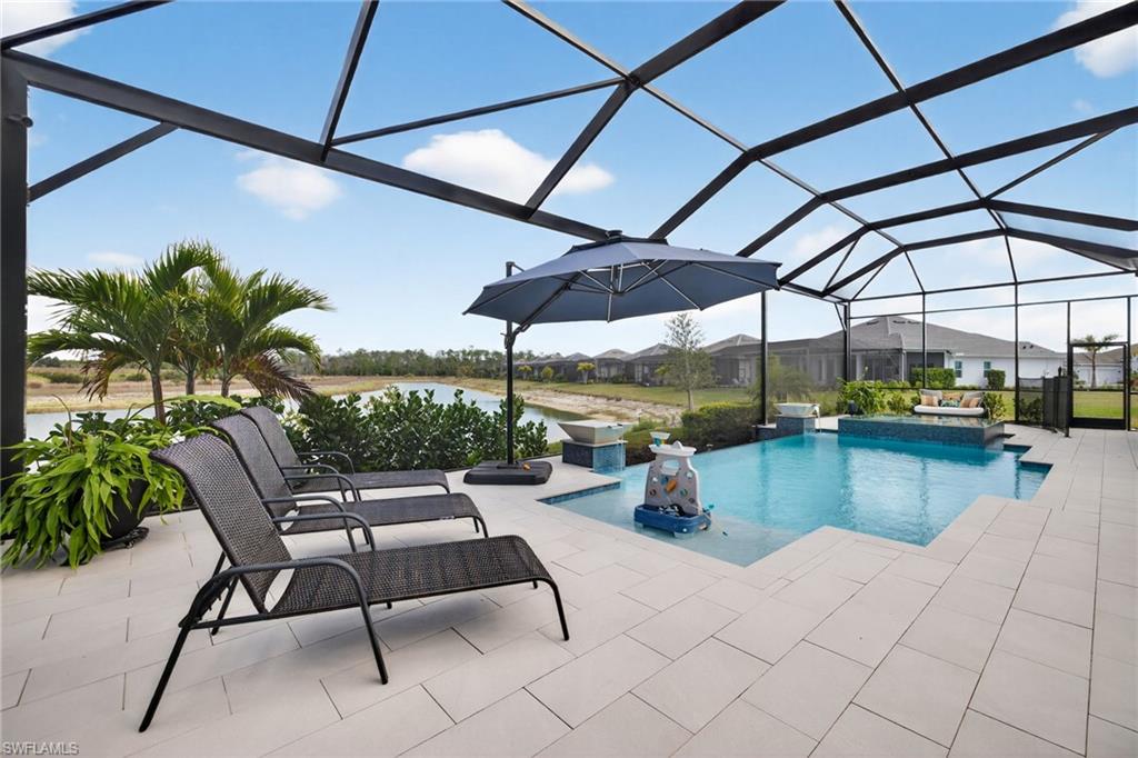 Outdoor pool featuring a lanai, a sunroom, a patio, and a residential view