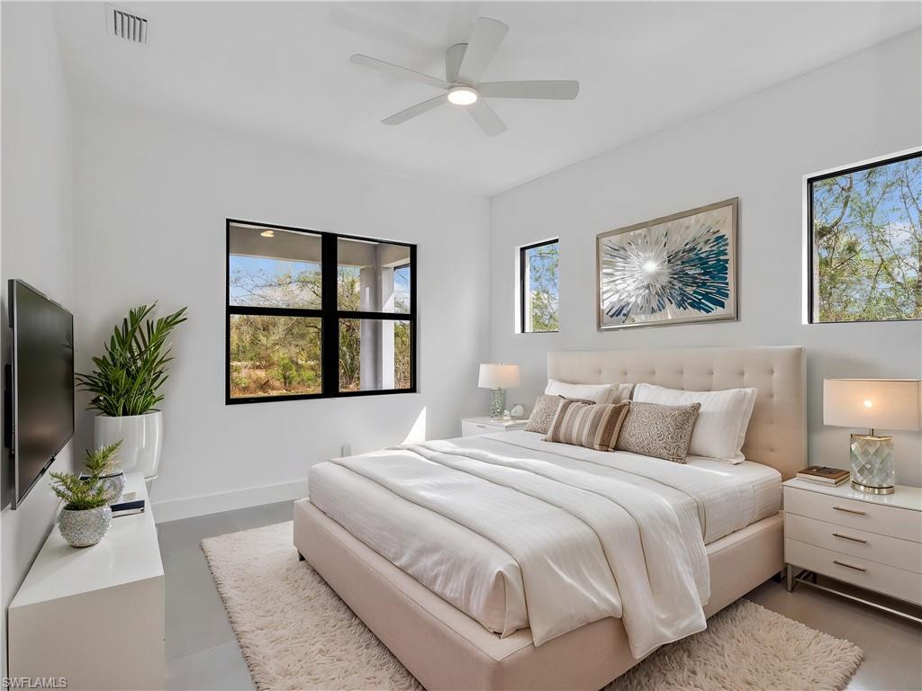 Bedroom featuring multiple windows and ceiling fan. This photo is virtually staged.