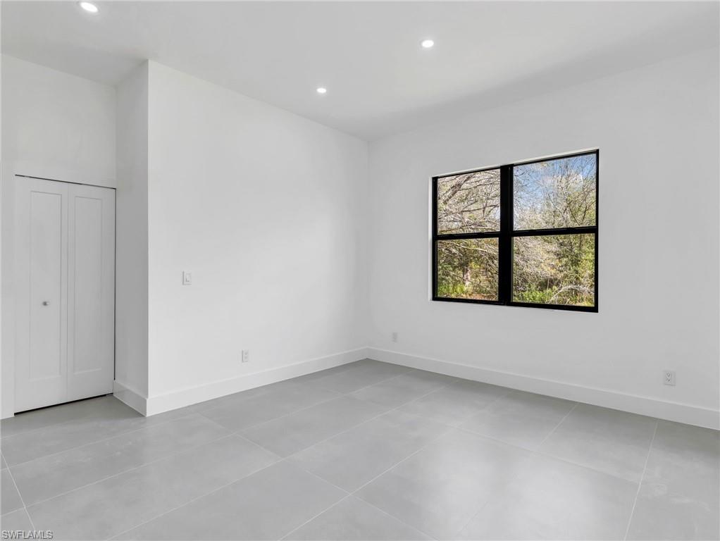 Unfurnished bedroom with baseboards and recessed lighting