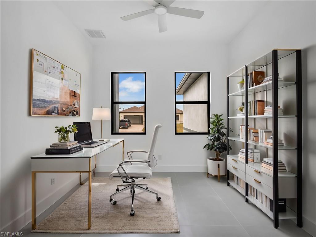 Home office featuring baseboards and a ceiling fan. This photo is virtually staged.